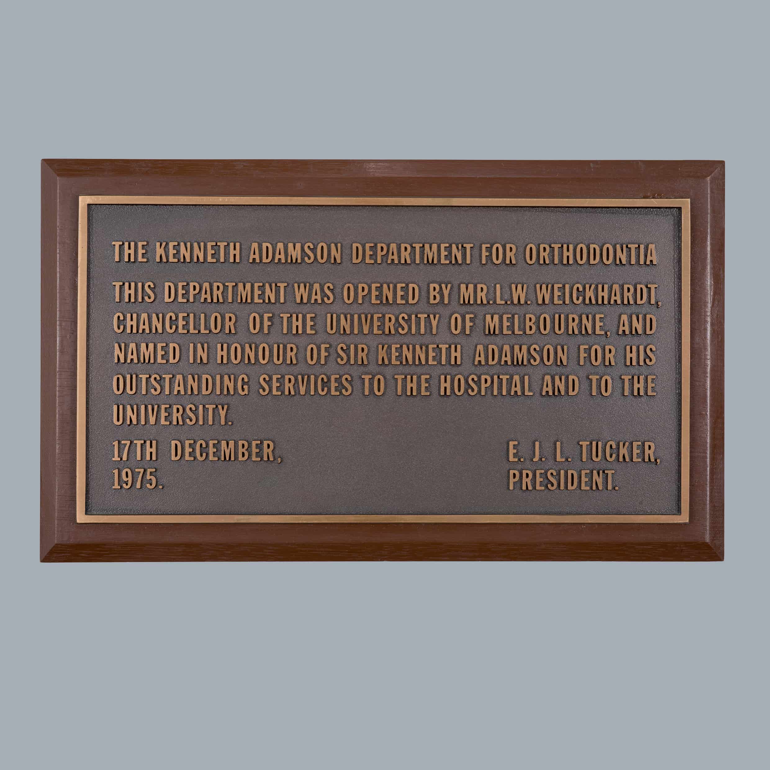  Plaque: The Kenneth Adamson Department for Orthodontia, 1975, bronze, wood, 30.0 × 20.0 × 0.5 cm. HFADM 2620, Henry Forman Atkinson Dental Museum, University of Melbourne.   
