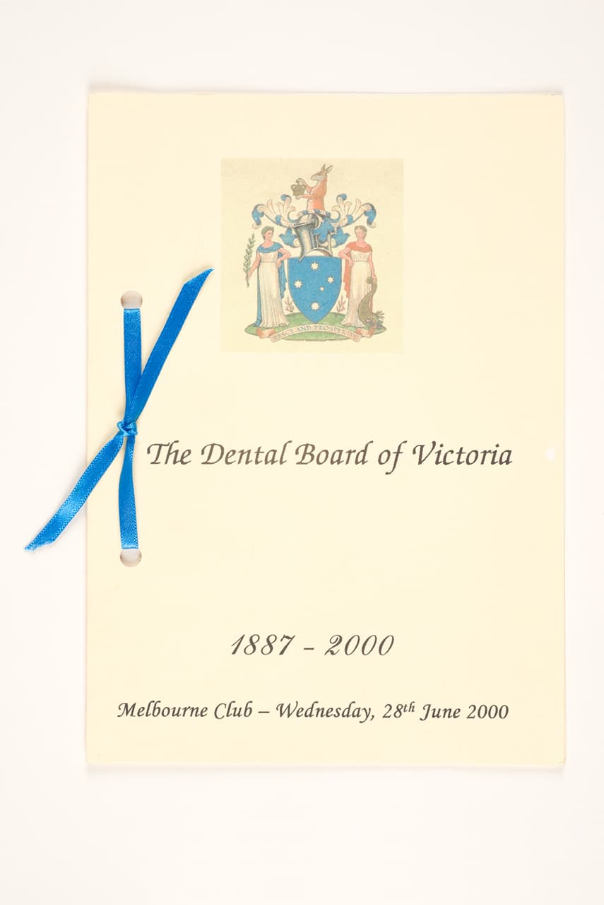 Dental Board of Victoria, Menu: Dental Board of Victoria 1887–2000, 2000, menu: print on paper, with card and ribbon, 21.0 × 15.0 cm. HFADM 3684, gift of the estate of Dr Vincent Amerena 2019, Henry Forman Atkinson Dental Museum, University of Melbourne.